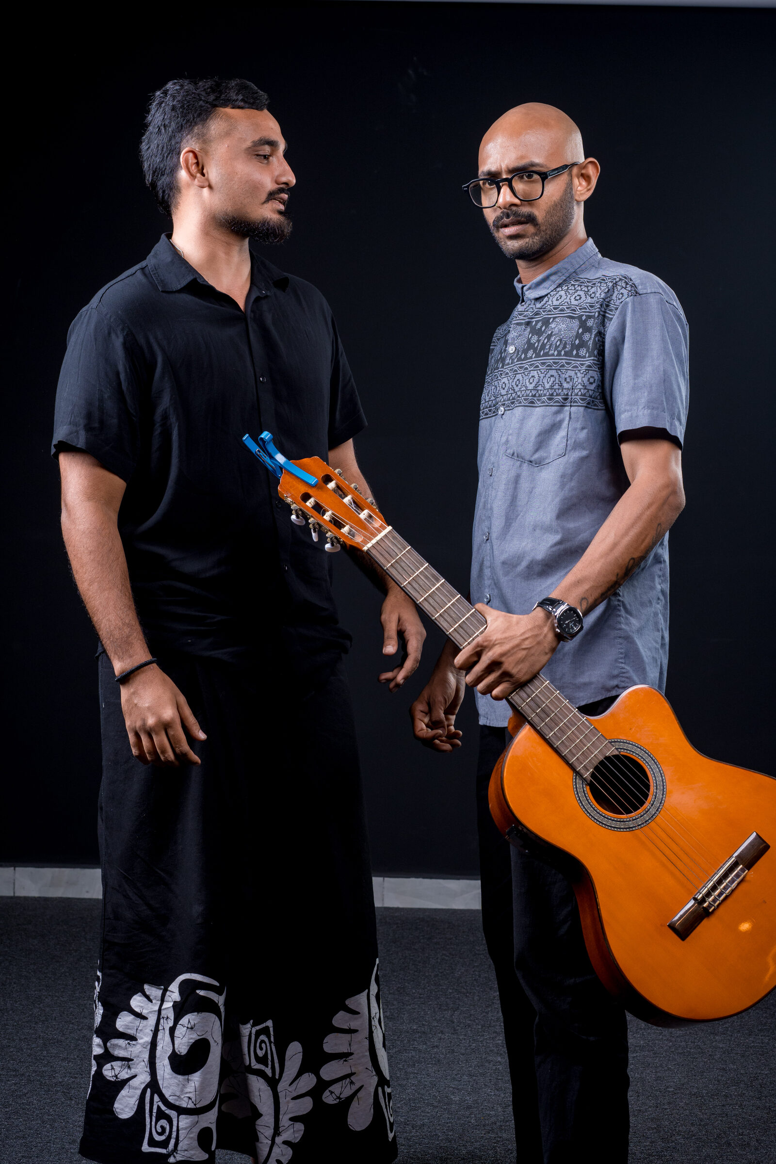 Portrait of the Authentic duo against a black backdrop