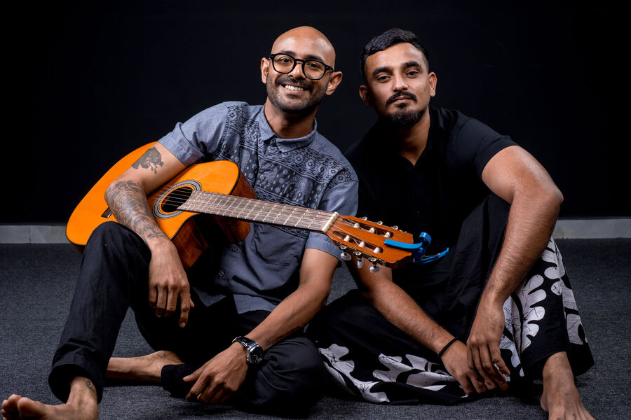 The duo seated, laughing